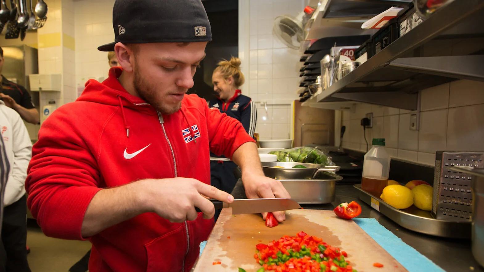 Kyron Duke preparing food in Sport Wales Athlete Training Kitchen